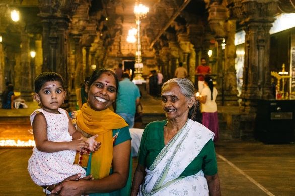 Three generations praying at the Shri Ponnambalawaneswaram Kovil temple in Colombo